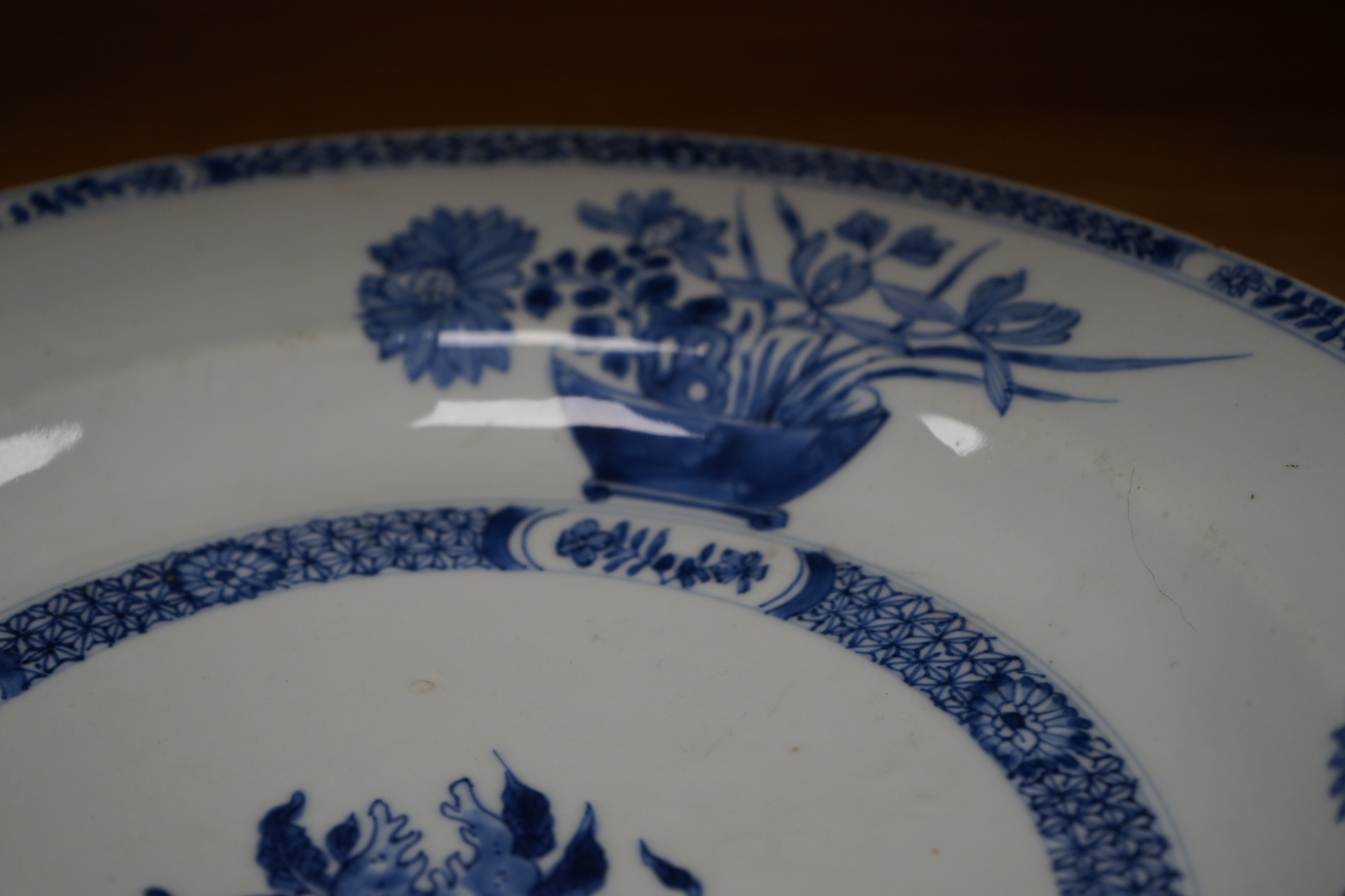 An 18th century Chinese blue and white circular dish decorated with flowering plants, Dia 32.5cm